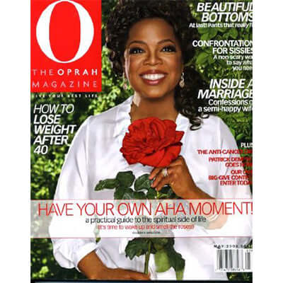 cover of oprah magazine shows woman smiling holding a red rose