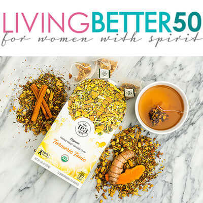 tea and ingredients lay on a marble surface next to a brewed cup of turmeric tonic blend