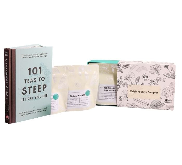 three tea bags sit in front of a box labeled origin reserve sampler next to the book 101 teas to steep before you die