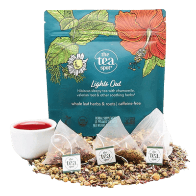 a bag reading lights out sits behind loose leaf tea, tea bags, and a tea cup
