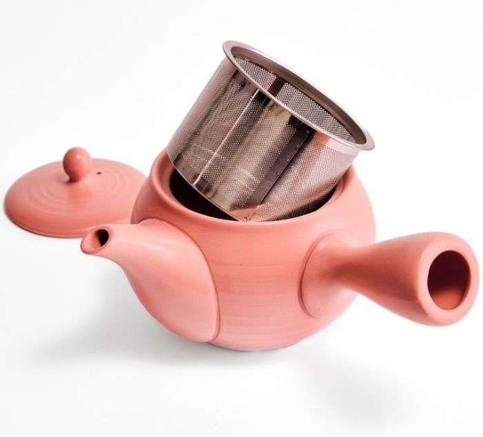a stainless steel infuser pulled out of a tokoname kyusu teapot