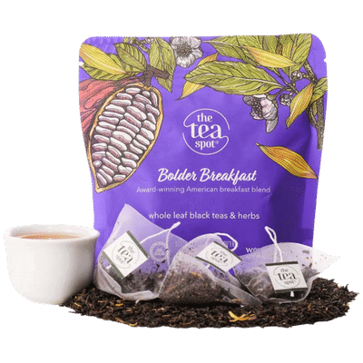 a bag reading bolder breakfast sits behind loose leaf tea, tea bags, and a tea cup