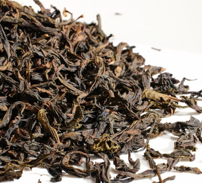Close-up of da hong pao tea leaves on a white background