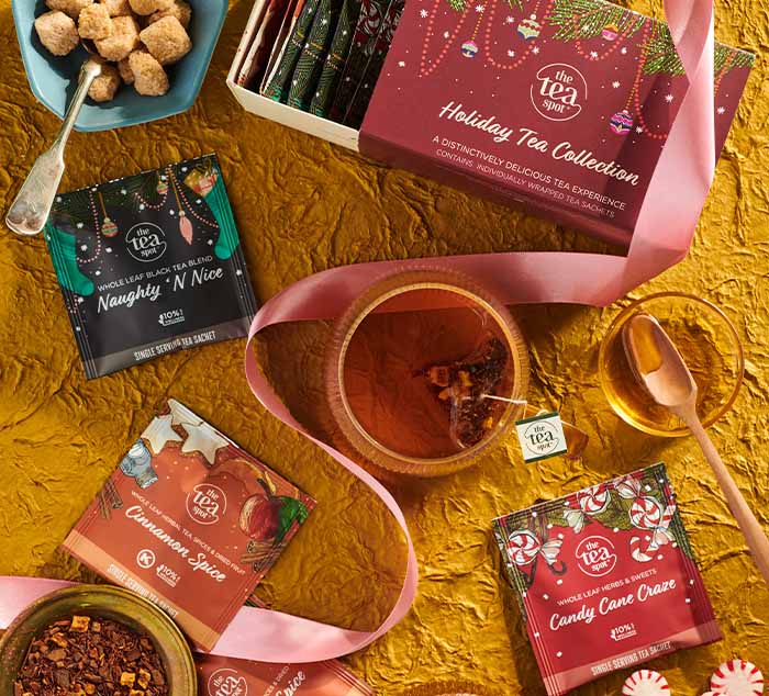a box reading holiday tea collection is surrounded by christmas teas, naughty n nice, cinnamon spice, and candy cane craze