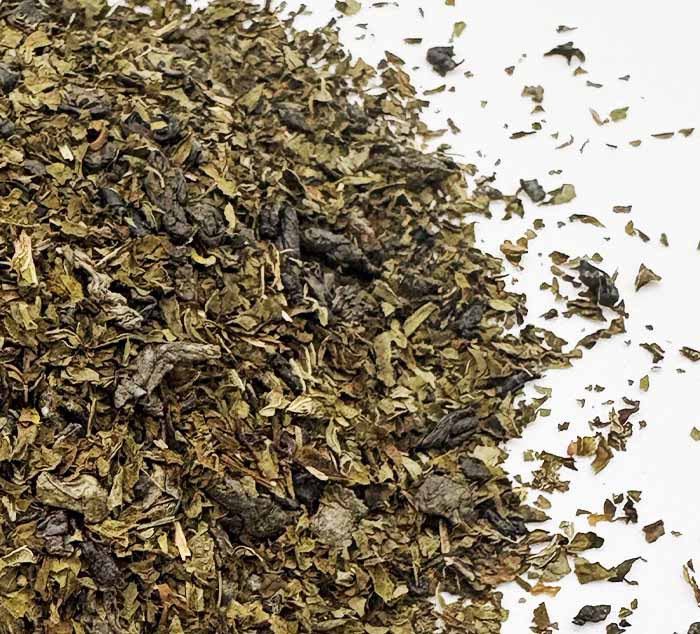 Moroccan mint green tea leaves on a white background