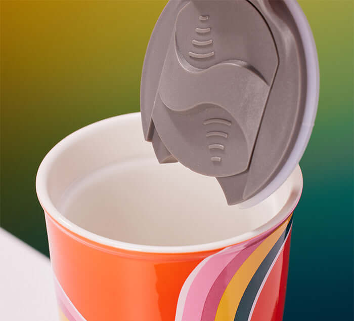 a plastic lid on top of a ceramic mug