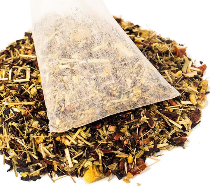 Hibiscus Cooler Iced Tea Pouch sits on a pile of loose tea blend