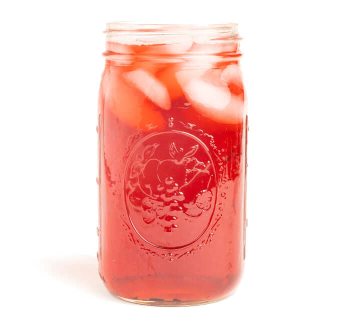 Hibiscus Iced Tea Brewed in a mason jar on a white background
