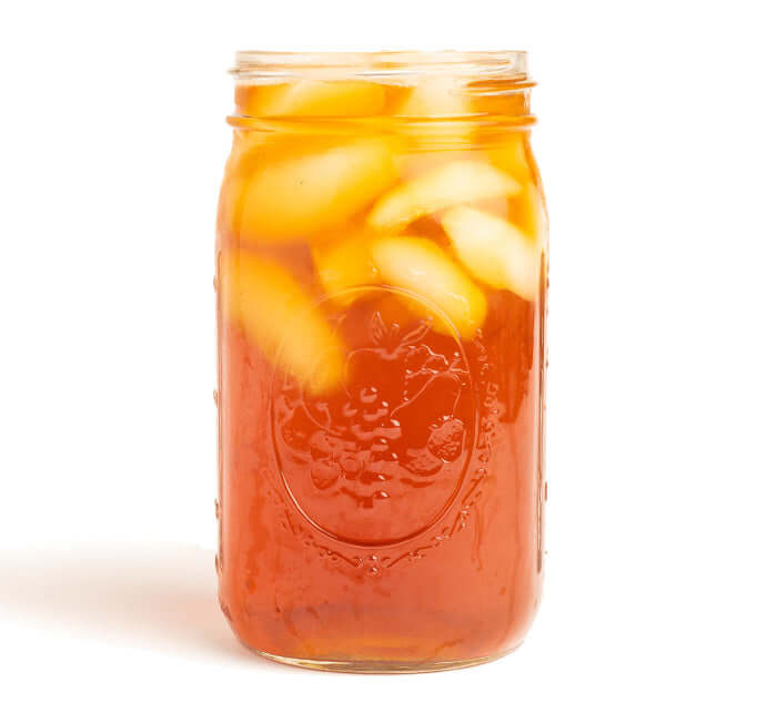 Nilgiri Black Iced Tea Brewed in a mason jar on a white background
