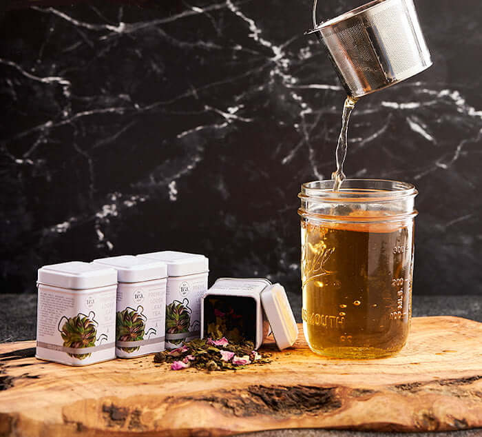 Loose Leaf Tea Set pictured with infuser being pulled from cup of tea