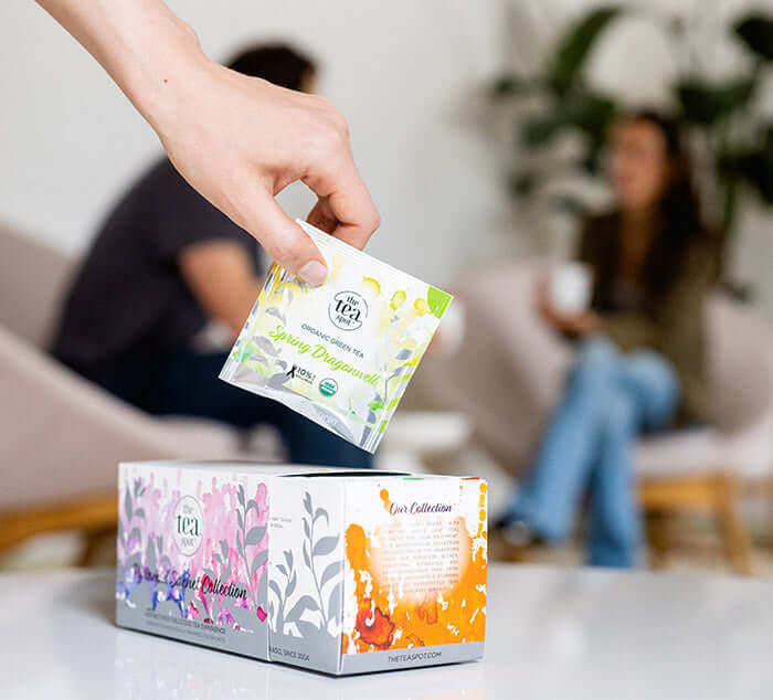 a hand pulls a sachet from Pyramid Sachet Sample Collection